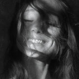 Ariana Grande – Petals poster featuring a black-and-white close-up portrait of Ariana Grande