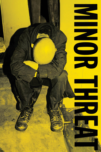 Minor Threat poster featuring the seated figure and bold vertical lettering of the yellow-and-black cover design