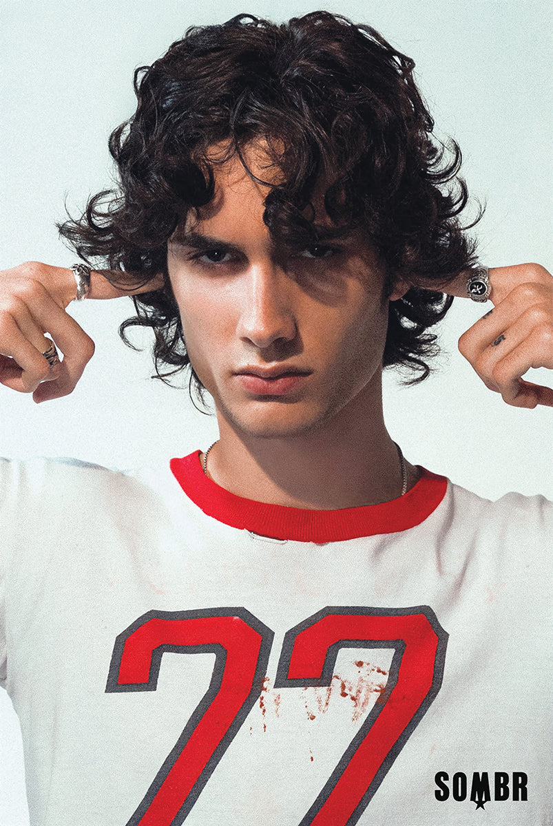 sombr poster featuring a close-up portrait of the artist in a red-trimmed number 77 shirt